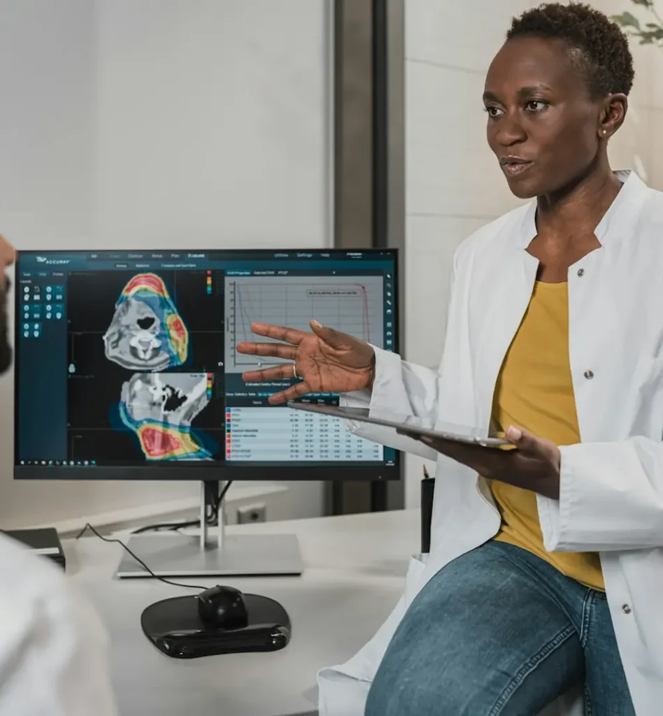 Two clinicians reviewing information together on a monitor